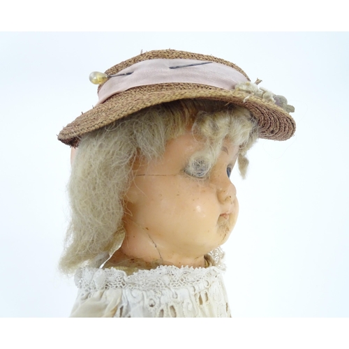 901 - Toy: A 20thC doll with wax head, glass eyes, painted features, composite arms and lower legs. Approx... 