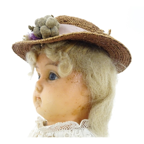 901 - Toy: A 20thC doll with wax head, glass eyes, painted features, composite arms and lower legs. Approx... 