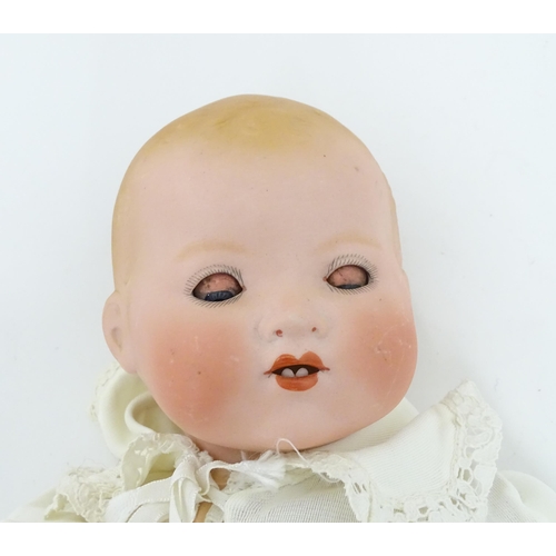 902 - Toy: An Armand Marseille doll with bisque head, blinking eyes, two front teeth, painted features and... 