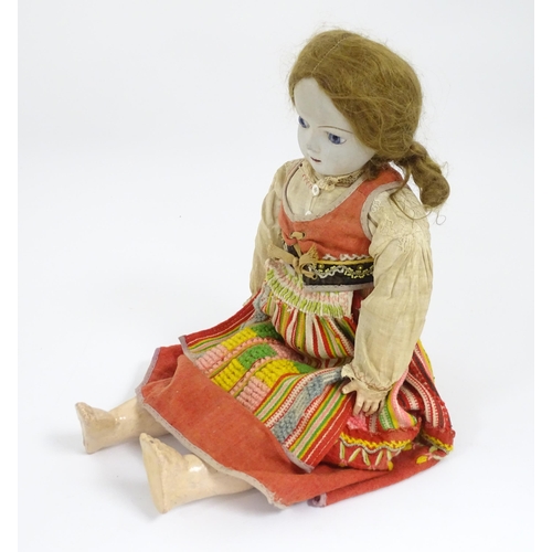 903 - Toy: A 20thC French doll with bisque head, glass eyes, painted features and a composite body with ar... 