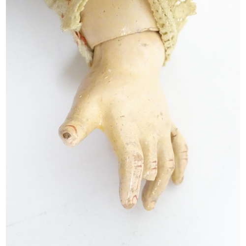 903 - Toy: A 20thC French doll with bisque head, glass eyes, painted features and a composite body with ar... 