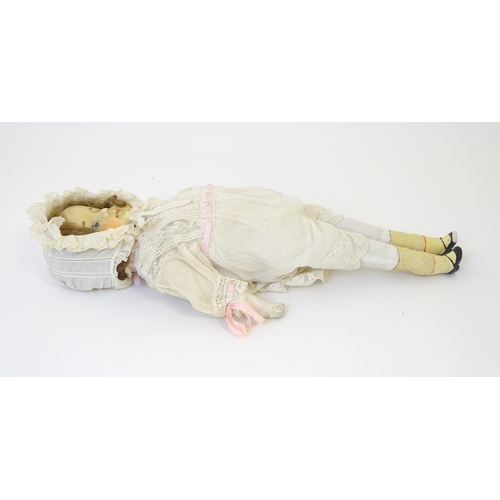 904 - Toy: A 20thC doll with wax head, glass eyes, painted features, composite arms and lower legs. Approx... 