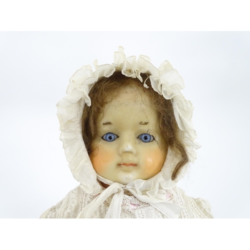 904 - Toy: A 20thC doll with wax head, glass eyes, painted features, composite arms and lower legs. Approx... 