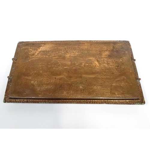 120 - A 20thC copper tray of rectangular form with twin handles and hammered decoration. Approx. 20 1/4