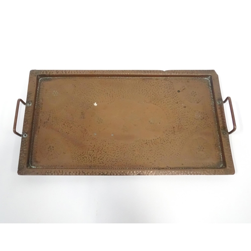 120 - A 20thC copper tray of rectangular form with twin handles and hammered decoration. Approx. 20 1/4