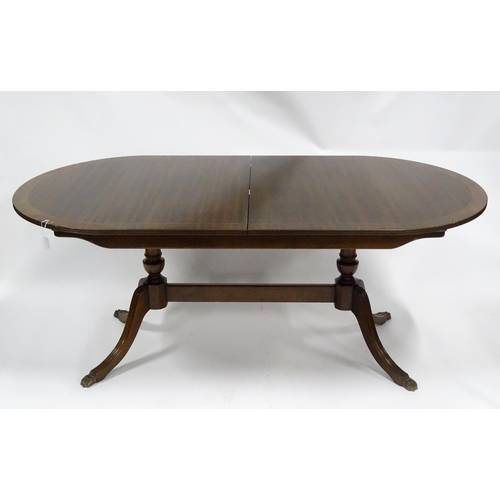 157 - A late 20thC mahogany dining table, with joined  pedestal base and shaped & inlaid top, approx 72