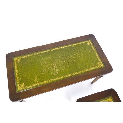 182 - A nest of three tables with gold tooled green leather tops. The largest measuring 30