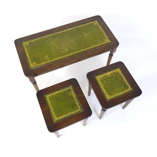 182 - A nest of three tables with gold tooled green leather tops. The largest measuring 30