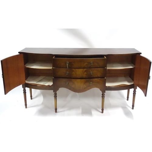 183 - A 20thC mahogany sideboard with shaped front,  comprising two cupboards with shelves and opposing do... 