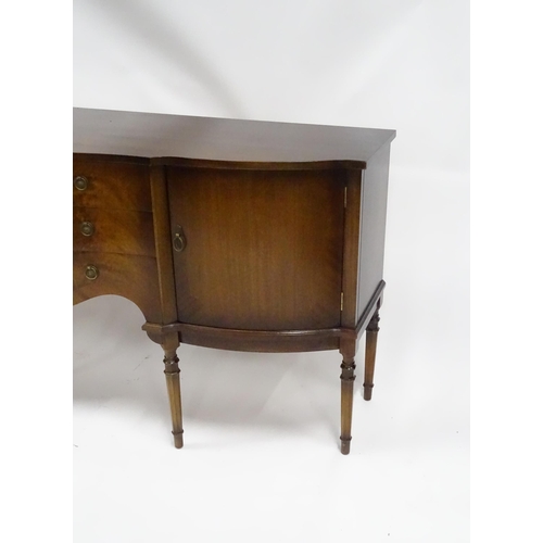 183 - A 20thC mahogany sideboard with shaped front,  comprising two cupboards with shelves and opposing do... 