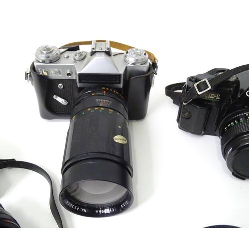 262 - A quantity of cameras and camera / photograph equipment to include a Canon AE-1, a Zenit E with Opto... 