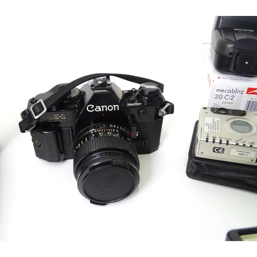 262 - A quantity of cameras and camera / photograph equipment to include a Canon AE-1, a Zenit E with Opto... 