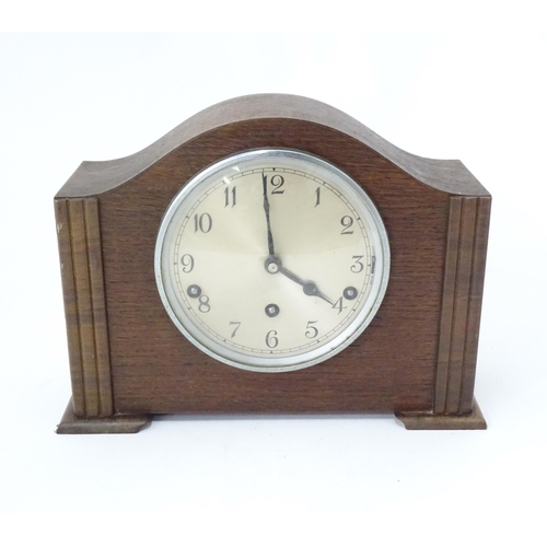 269 - An Art Deco oak cased mantle clock by Garrard. With chiming movement.  Approx. 9