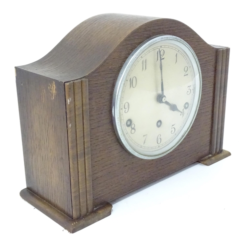 269 - An Art Deco oak cased mantle clock by Garrard. With chiming movement.  Approx. 9