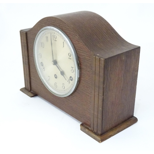 269 - An Art Deco oak cased mantle clock by Garrard. With chiming movement.  Approx. 9