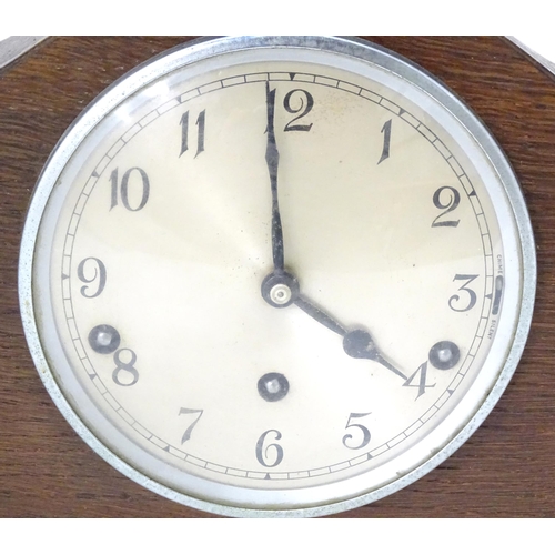 269 - An Art Deco oak cased mantle clock by Garrard. With chiming movement.  Approx. 9