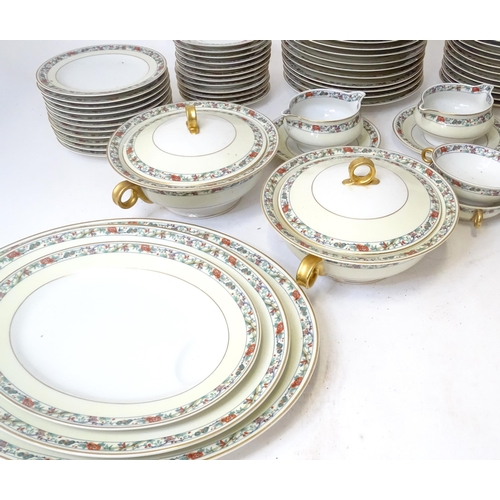 283 - A quantity of Haviland Limoges dinner wares with banded foliate border, to include plates, serving p... 