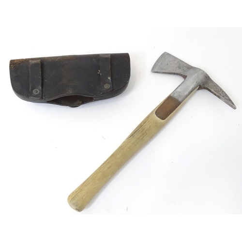 302 - A Fireman's axe with leather head cover. Approx. 15 1/4