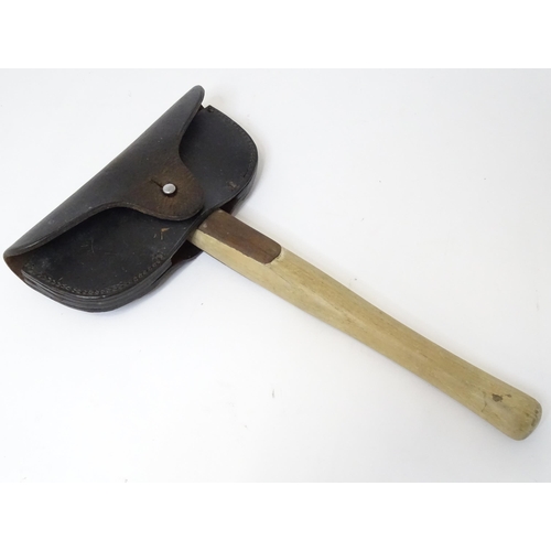 302 - A Fireman's axe with leather head cover. Approx. 15 1/4