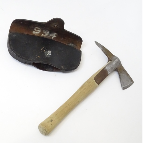 302 - A Fireman's axe with leather head cover. Approx. 15 1/4