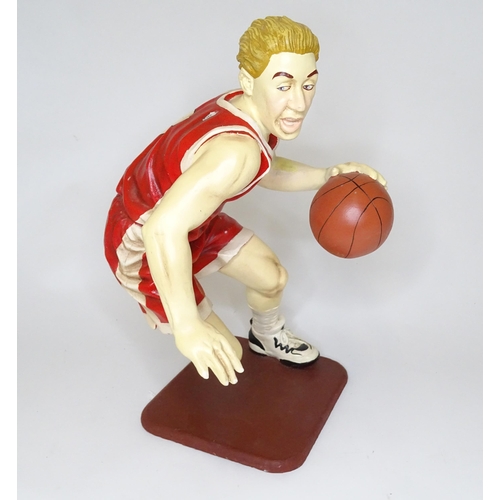 313 - A model of a basketball player with cast signature for Jun Asilo 97. Approx. 17 1/2