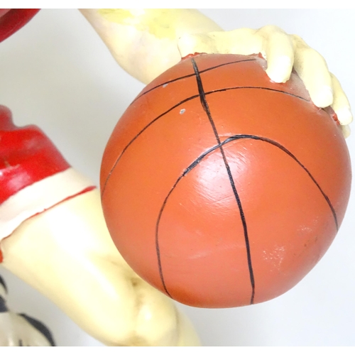 313 - A model of a basketball player with cast signature for Jun Asilo 97. Approx. 17 1/2