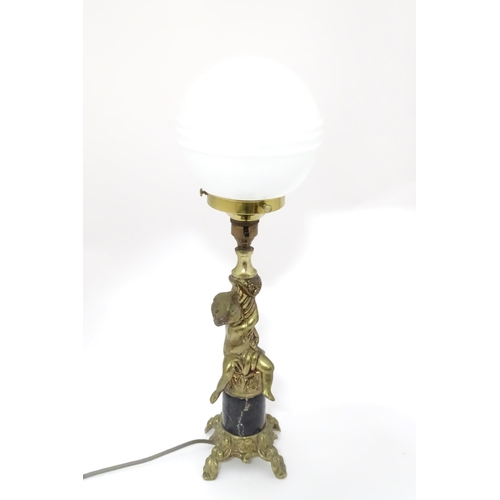 334 - A 20thC cast table lamp with cherub detail to column. Approx. 18 1/2