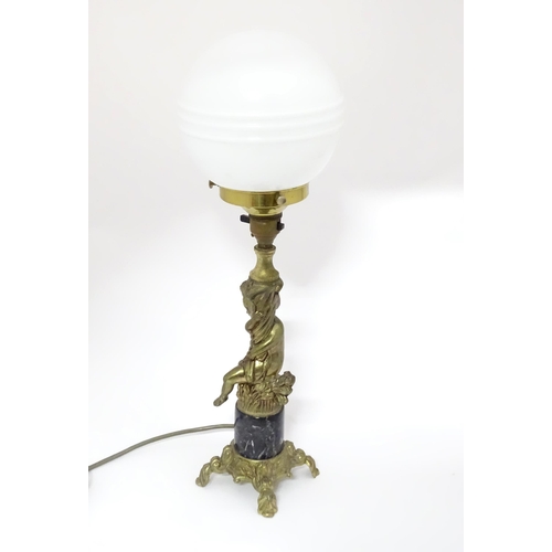 334 - A 20thC cast table lamp with cherub detail to column. Approx. 18 1/2