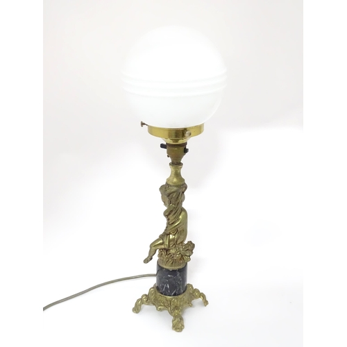 334 - A 20thC cast table lamp with cherub detail to column. Approx. 18 1/2