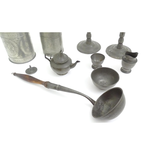 346 - A quantity of pewter items to include a pair of candlesticks, ladle, pot and cover, teapot of small ... 