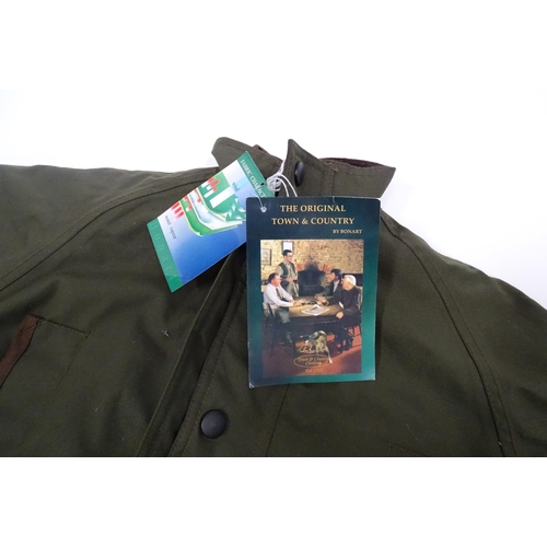 360 - Country clothing : a Bonart Keeper child's waterproof shooting jacket, in olive green, with handwarm... 