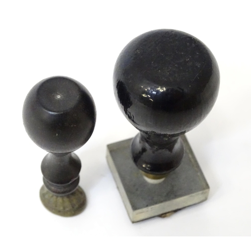 403 - A hand / desk seal and a stamp with ebonised handles. Largest approx. 2 1/2