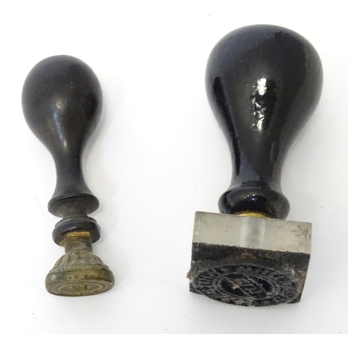 403 - A hand / desk seal and a stamp with ebonised handles. Largest approx. 2 1/2