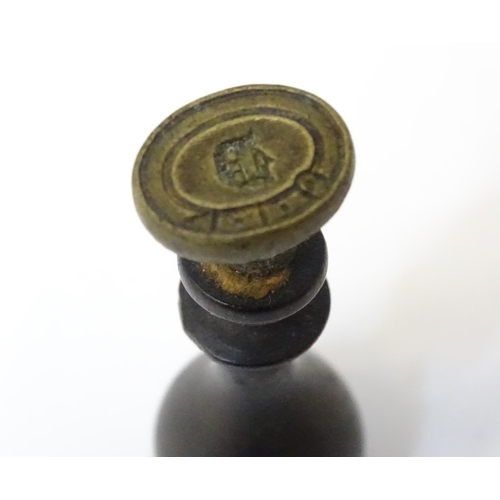 403 - A hand / desk seal and a stamp with ebonised handles. Largest approx. 2 1/2