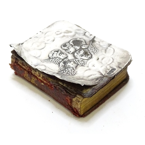 410 - A miniature prayer book with silver front cover with embossed angel detail. hallmarked Birmingham 19... 