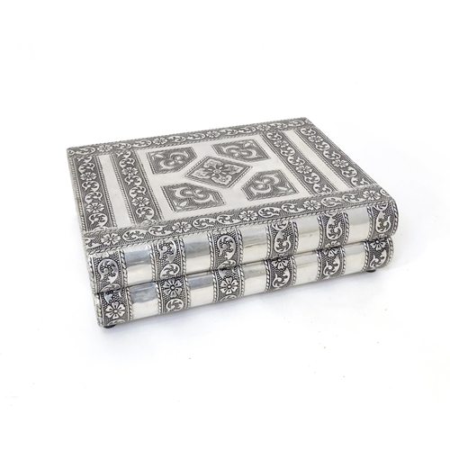 444 - An eastern style white metal jewellery box formed as two books,  with fitted sectional interior. Tog... 