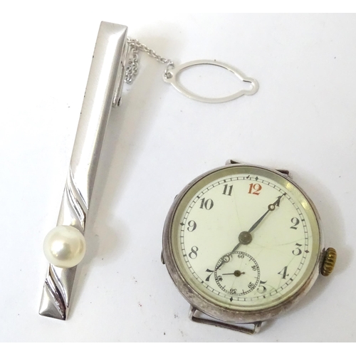 542 - A silver tie clip together with a silver cased watch and a gilt metal stick pin surmounted by enamel... 