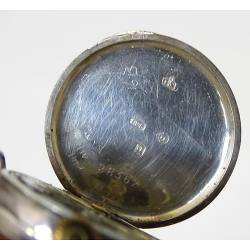 542 - A silver tie clip together with a silver cased watch and a gilt metal stick pin surmounted by enamel... 