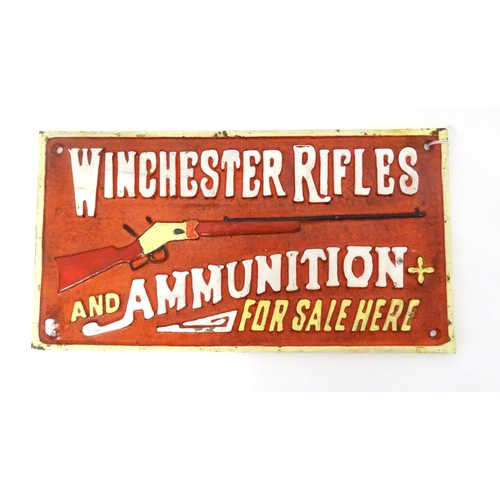 590 - A reproduction cast sign titled Winchester Rifles and Ammunition For Sale Here. Approx. 6 1/2