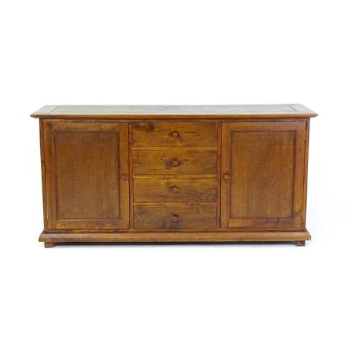 627 - A late 20thC sideboard / dresser base with four short drawers flanked by two panelled cupboard doors... 