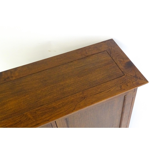 627 - A late 20thC sideboard / dresser base with four short drawers flanked by two panelled cupboard doors... 