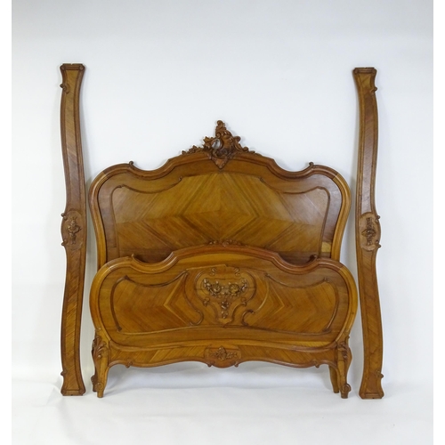 662 - An early /mid 20thC Louis XV style bed with kingwood style veneering. 78