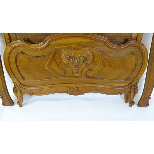 662 - An early /mid 20thC Louis XV style bed with kingwood style veneering. 78