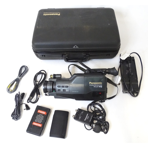 666 - A cased Panasonic MC90 VHS-C video camera.