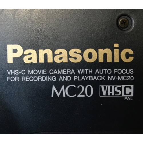 666 - A cased Panasonic MC90 VHS-C video camera.