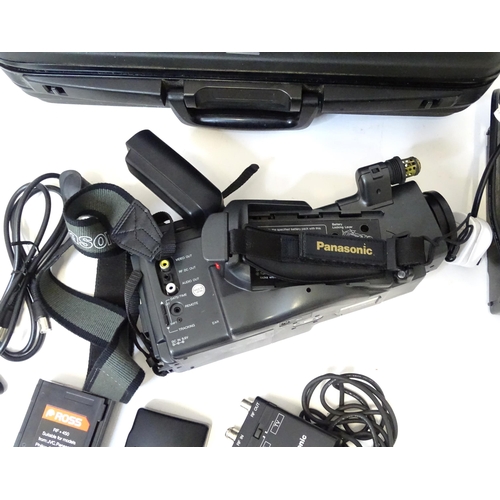 666 - A cased Panasonic MC90 VHS-C video camera.