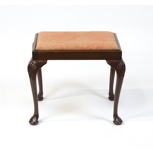 668 - An early 20thC Queen Anne style stool with a rectangular drop in seat raised on four cabriole legs w... 