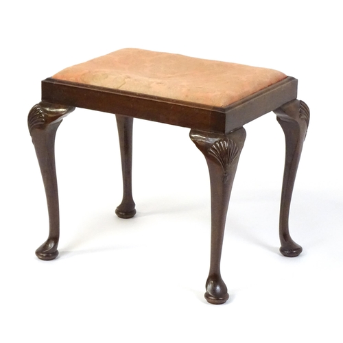 668 - An early 20thC Queen Anne style stool with a rectangular drop in seat raised on four cabriole legs w... 