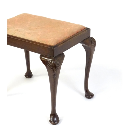 668 - An early 20thC Queen Anne style stool with a rectangular drop in seat raised on four cabriole legs w... 