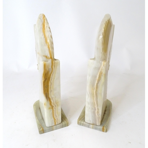 674 - A pair of onyx bookends of horse head form. Approx. 12